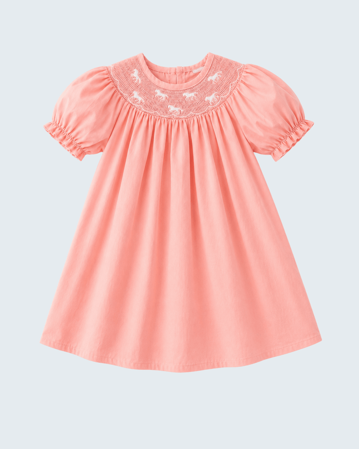 Pink dress with embroidery on a light gray background