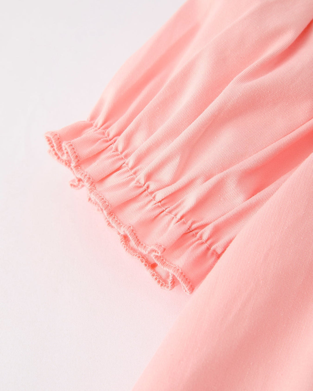 Close-up of a pink dress with a white background
