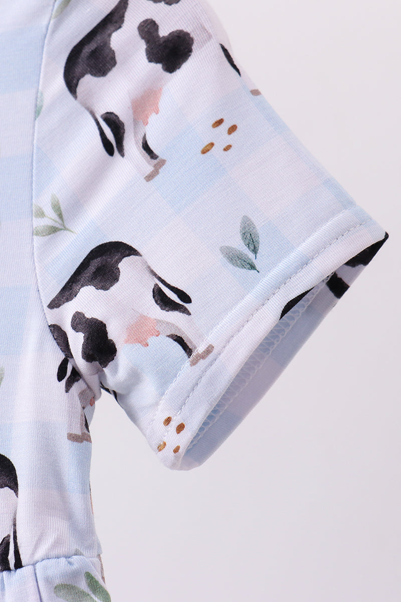 Girl Dress with cow print on a light blue background