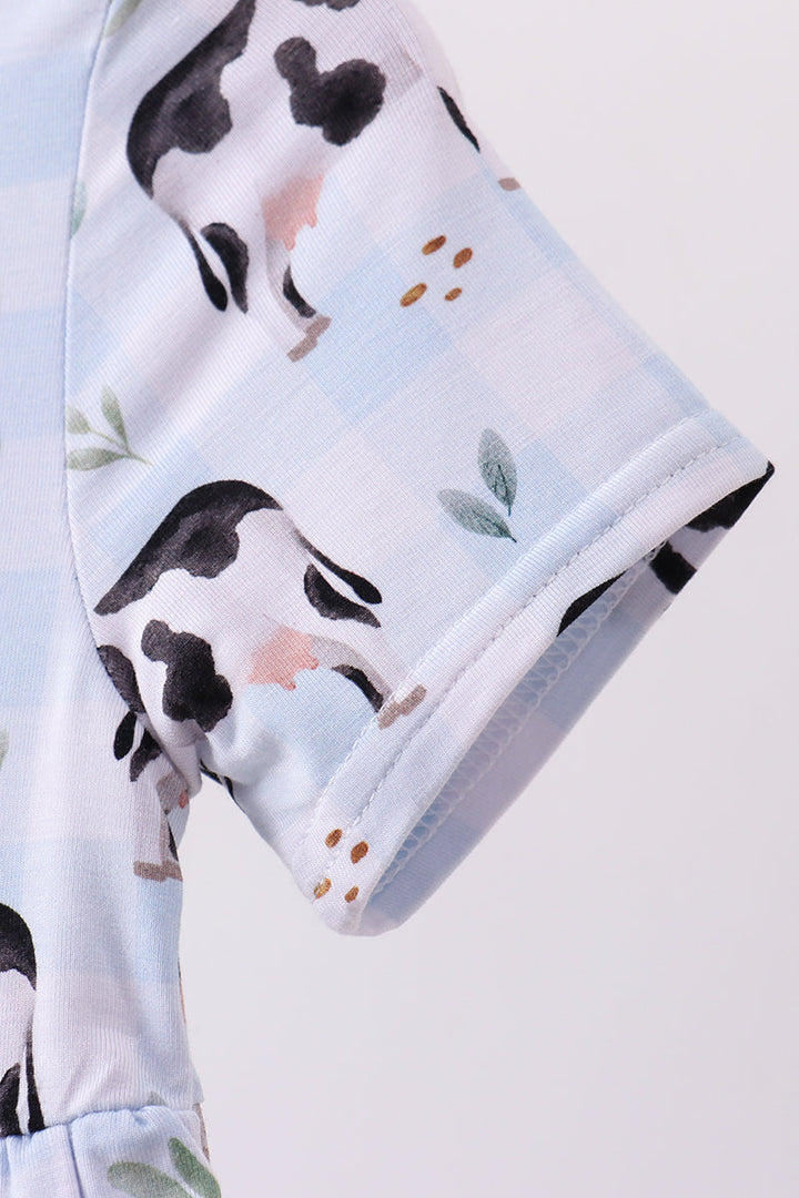Girl Dress with cow print on a light blue background
