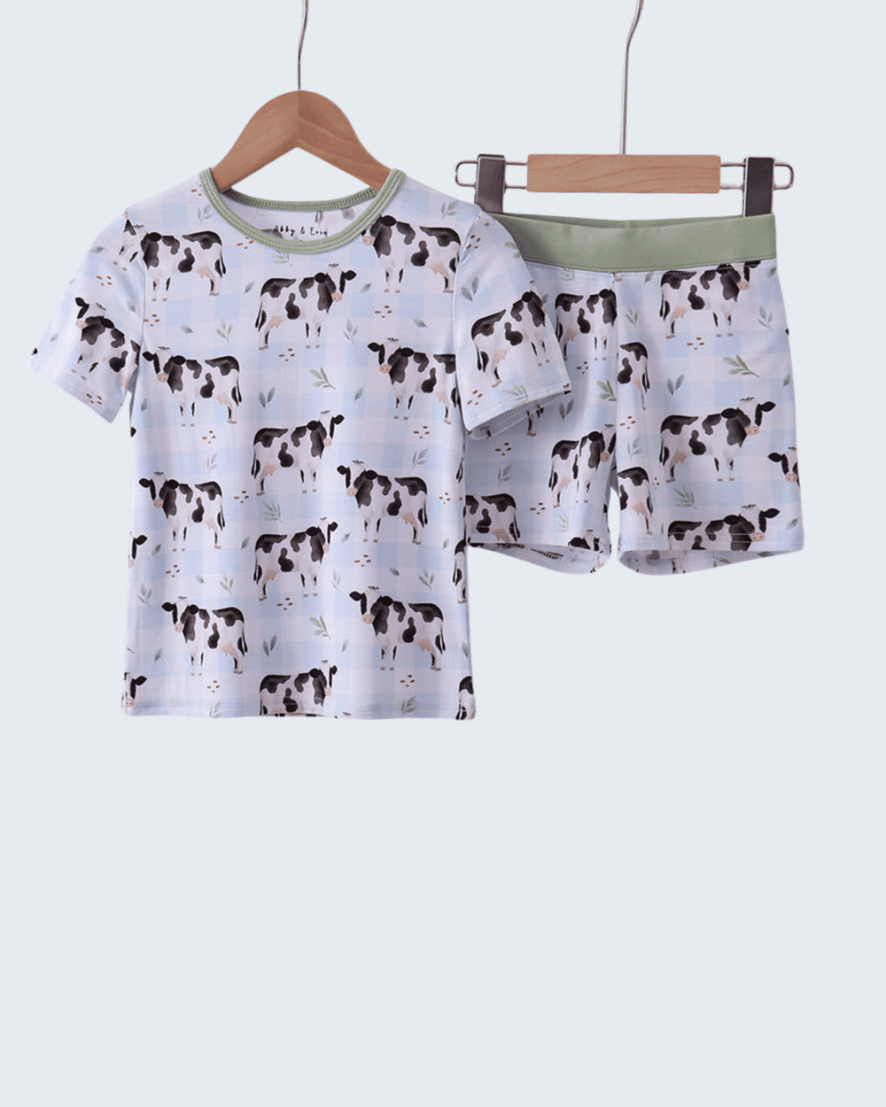 Children's pajama set with cow pattern on a white background