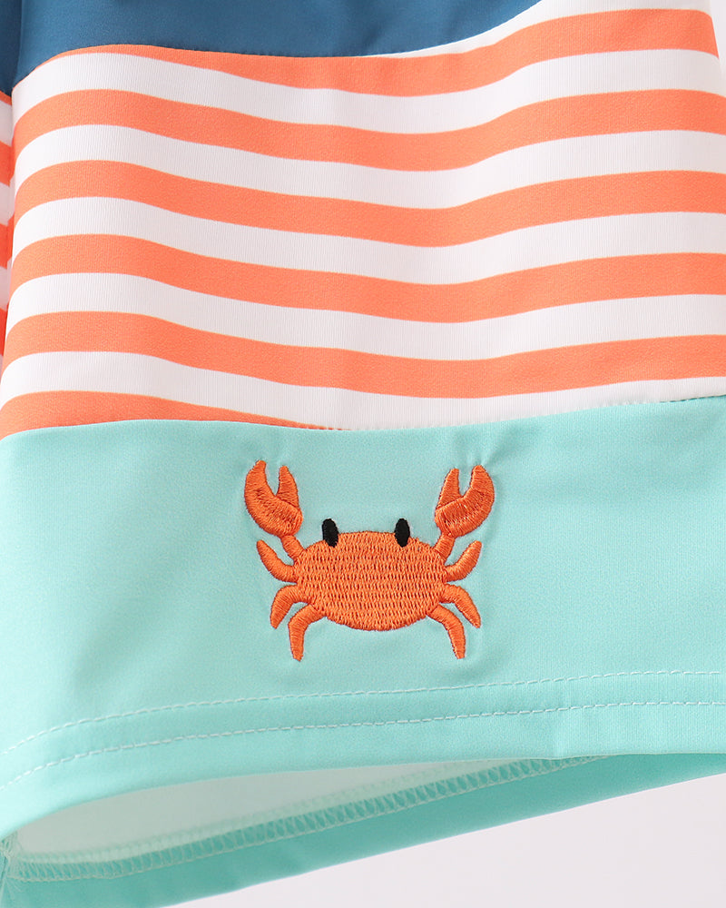 Striped swimsuit with a crab design on a white background