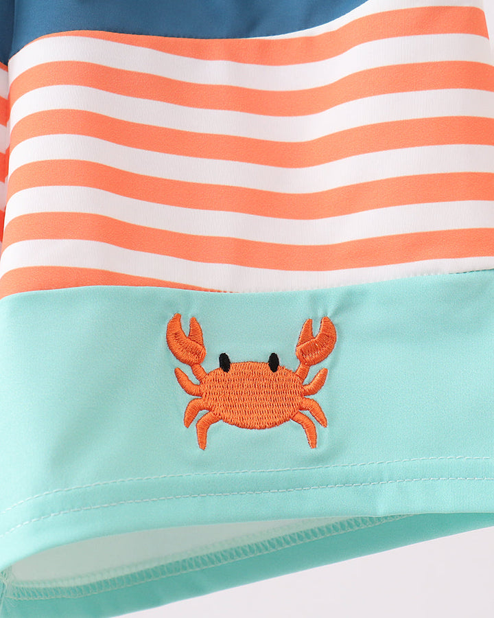 Striped swimsuit with a crab design on a white background