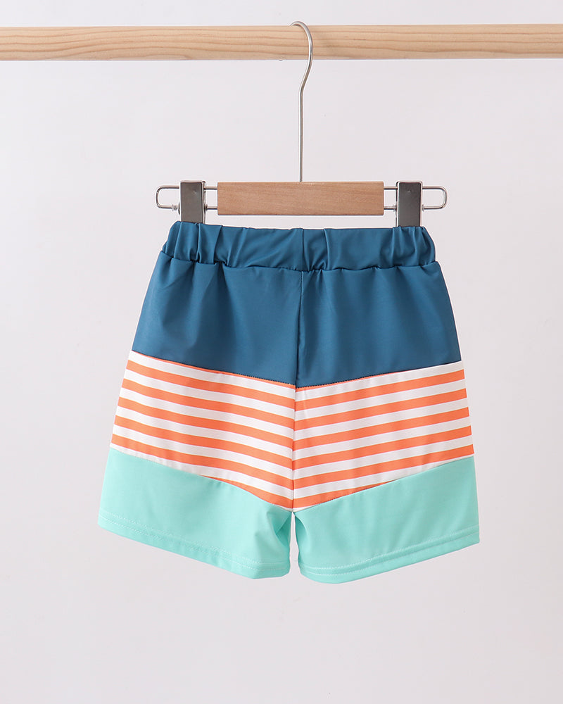 Color-blocked shorts with stripes on a hanger against a white background