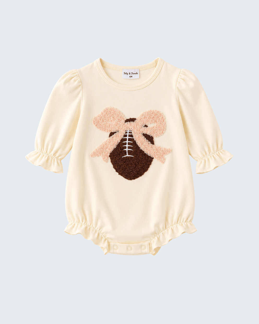 Cream long-sleeve baby romper with football applique, ruffled cuffs and snap bottom