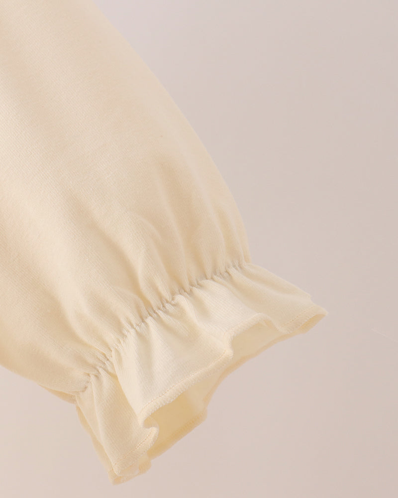 Cream long-sleeve dress with ruffled cuff and gathered sleeve hem