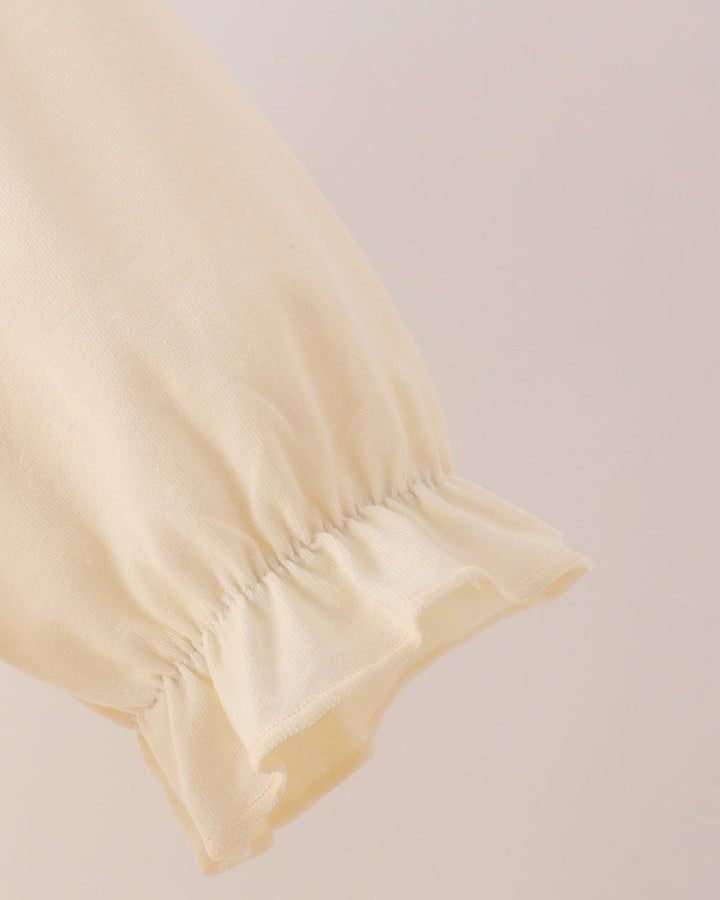 Cream long-sleeve dress with ruffled cuff and gathered sleeve hem