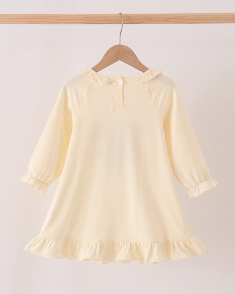 Cream long-sleeve ruffle dress with gathered neckline, cuffs, and flared hem
