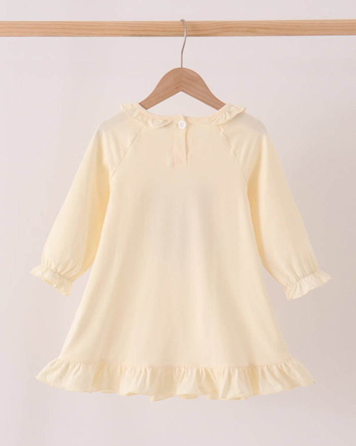 Cream long-sleeve ruffle dress with gathered neckline, cuffs, and flared hem