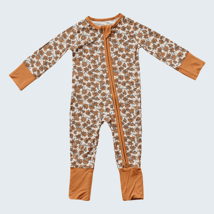 Floral-patterned onesie with brown accents on a light gray background