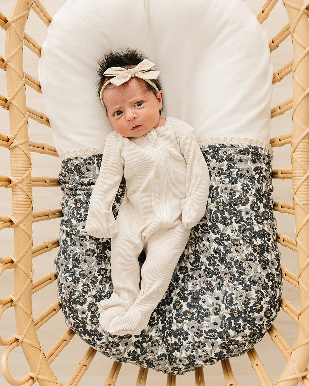 Cream ribbed bamboo zipper romper on baby, full-length zip front and cuffs