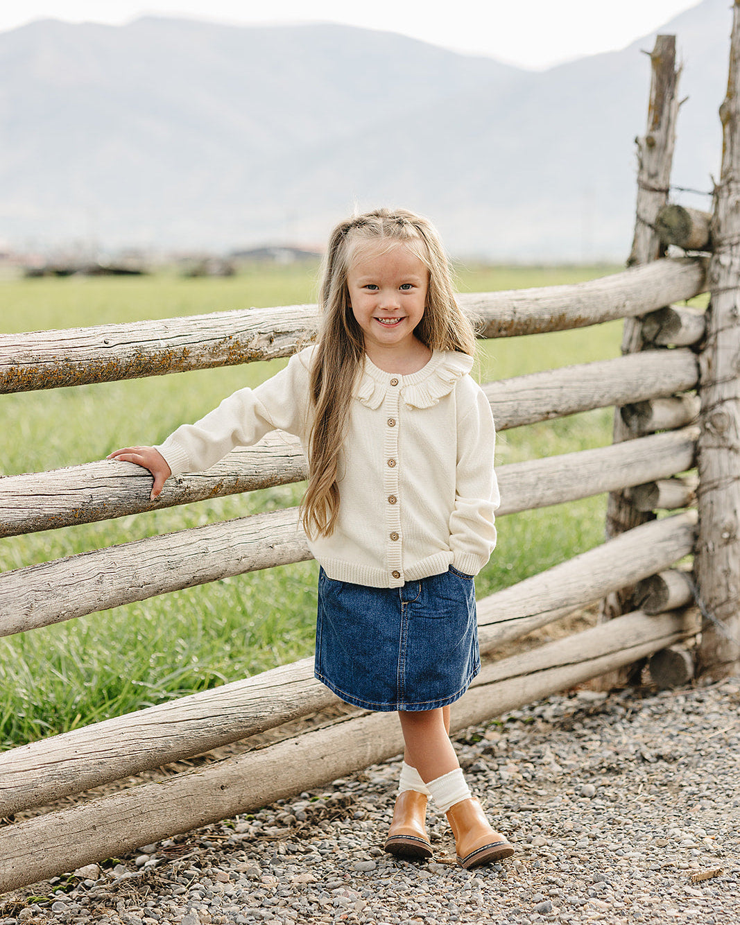 Cream ruffle knit cardigan with button-front and scalloped trim