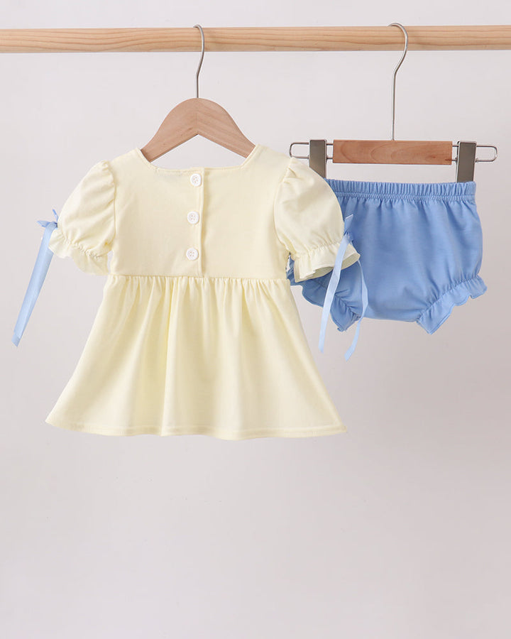 Cream smocked baby dress with bow sleeves and blue-trim bloomer on hangers