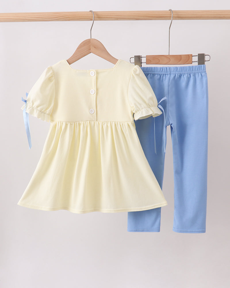 Cream peplum-style top and light blue pants set with bow ties
