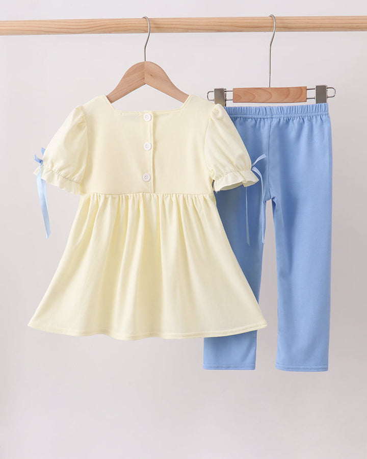 Cream peplum-style top and light blue pants set with bow ties