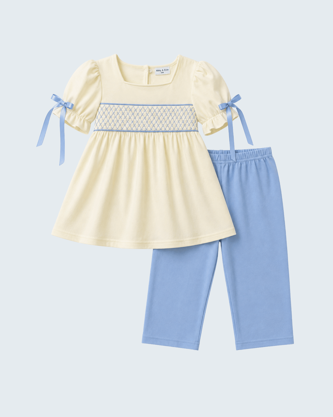 Cream smocked bow dress top with puff sleeves and light blue pants, set