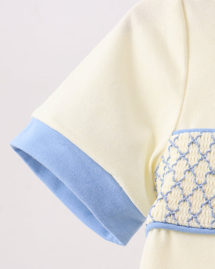 Cream top sleeve with light blue cuff and smocked waistband panel detail