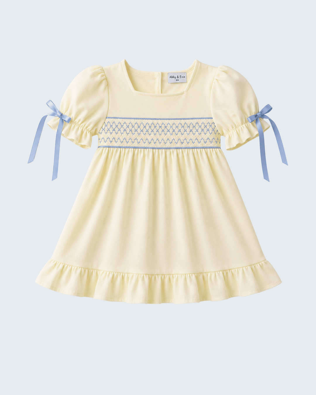 Cream smocked ruffle dress, puff sleeves with blue ribbon bows, tiered hem
