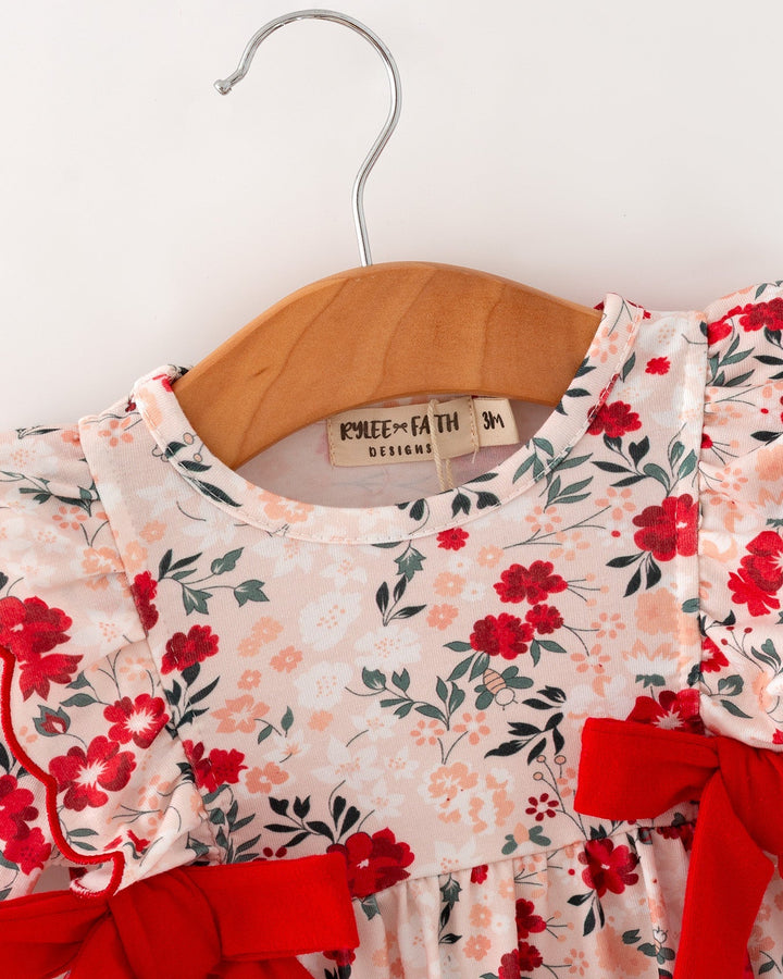 Floral baby girl romper with red neck bow and long-sleeve ruffle cuffs