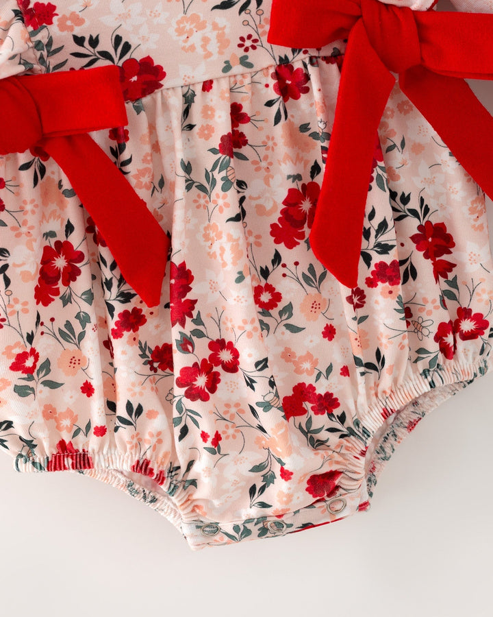 Floral baby girl romper with red bow ties and gathered ruffle legs