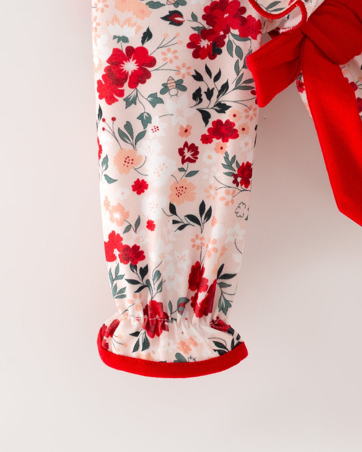 Floral baby girl romper with red trim and long sleeves