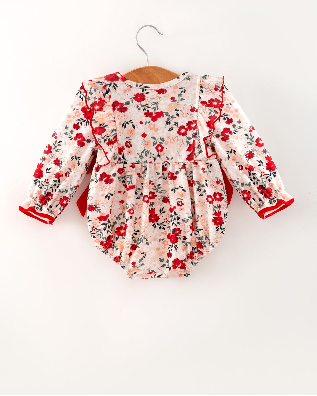 Floral baby girl romper with red bow detail and long sleeves