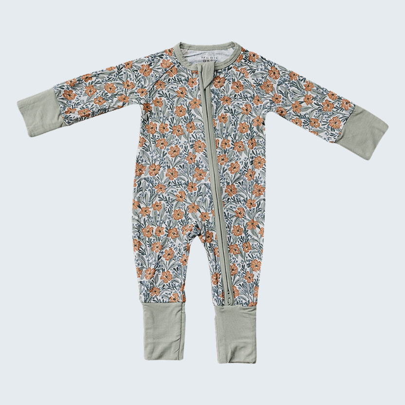 Floral-patterned baby onesie with gray cuffs and hem on a white background