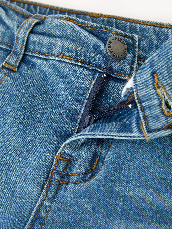 Girls denim jeans close-up of waistband, button fly, and stitched pocket