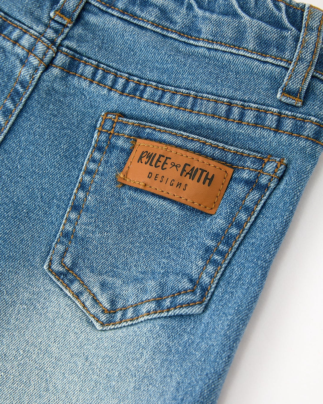 Girls denim jeans with leather-look logo patch on front pocket