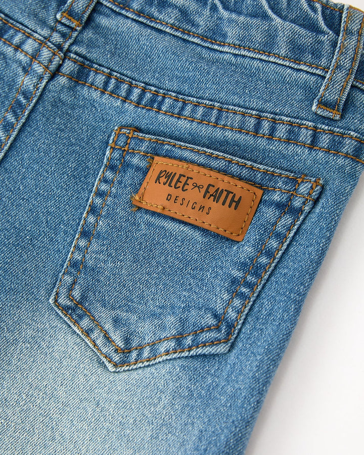 Girls denim jeans with leather-look logo patch on front pocket