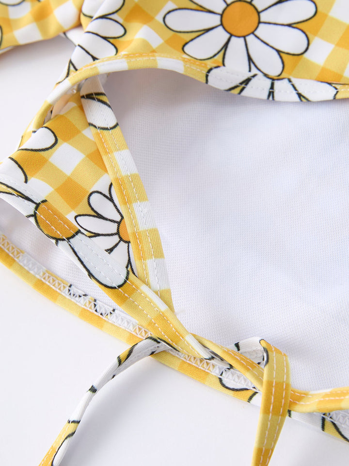 Close-up of a yellow and white floral-patterned headband on a white background