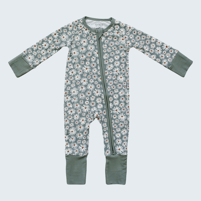 Baby onesie with floral pattern on a light blue background