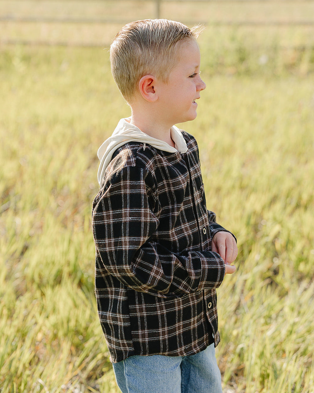 Plaid hooded button-up shirt viewed from side, long sleeves, front buttons