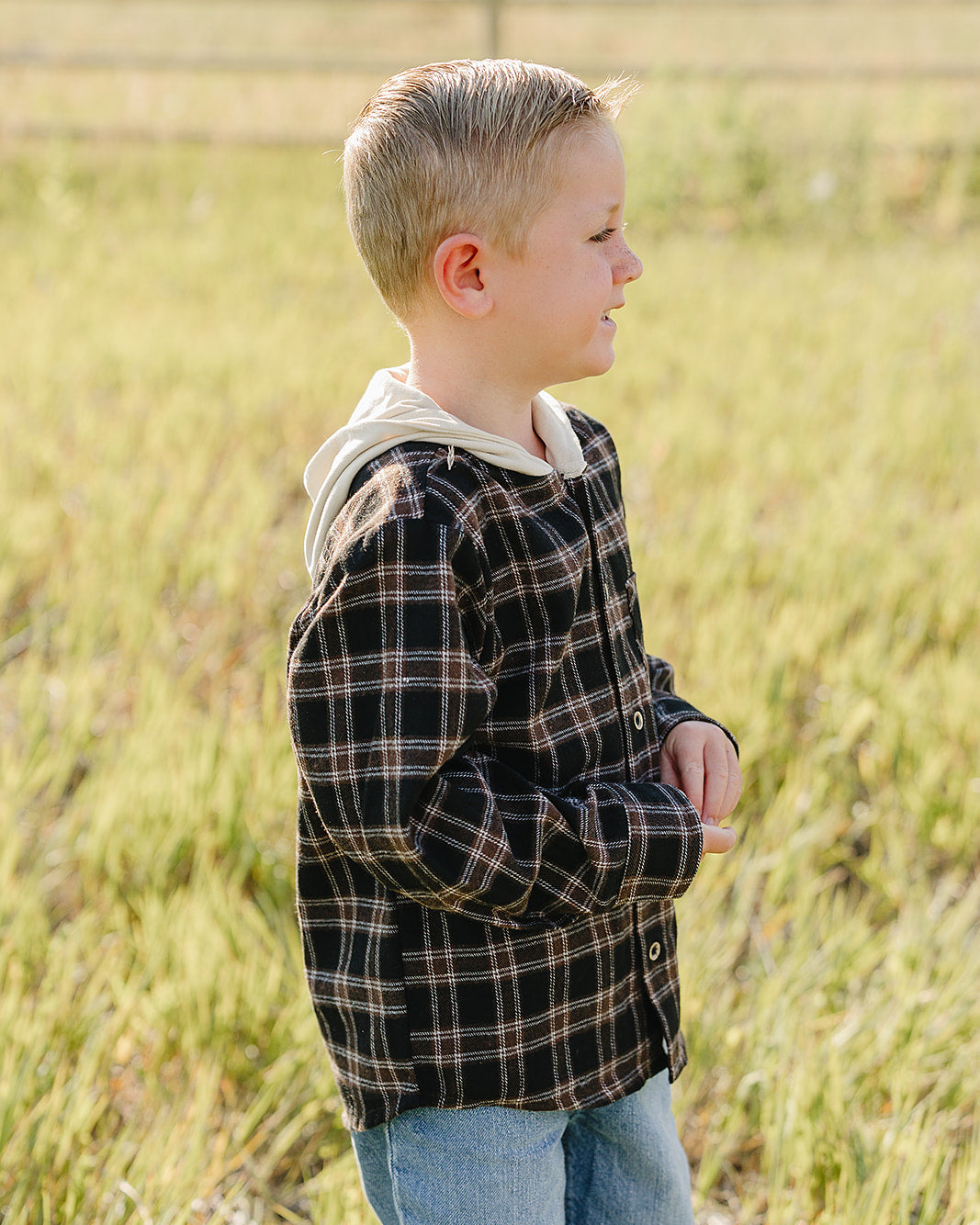 Plaid hooded button-up shirt viewed from side, long sleeves, front buttons