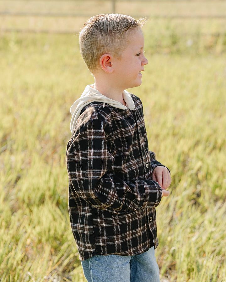 Plaid hooded button-up shirt viewed from side, long sleeves, front buttons