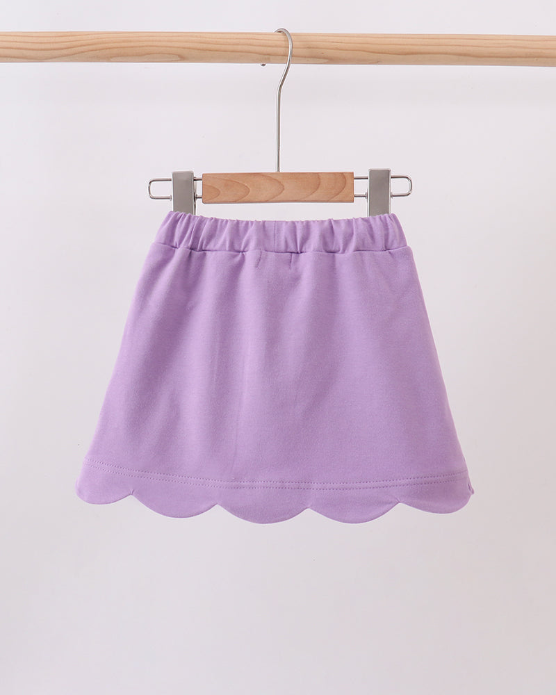 Dark purple skort on hanger with scalloped hem and elastic waistband
