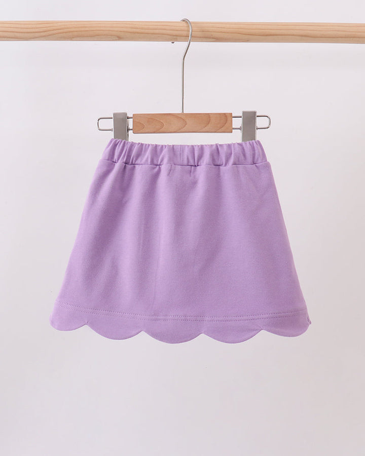 Dark purple skort on hanger with scalloped hem and elastic waistband
