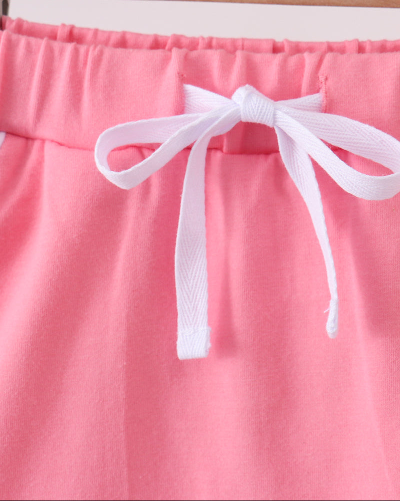 Deep pink toddler skort with white bow, elastic waistband, and scallop hem