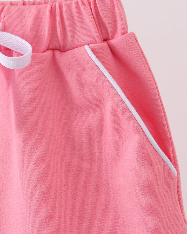 Deep pink skort side view with white drawstring tie and gathered elastic waist