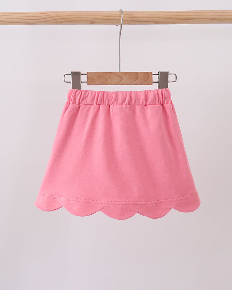 Deep pink kids skort on hanger with elastic waistband and scallop hem