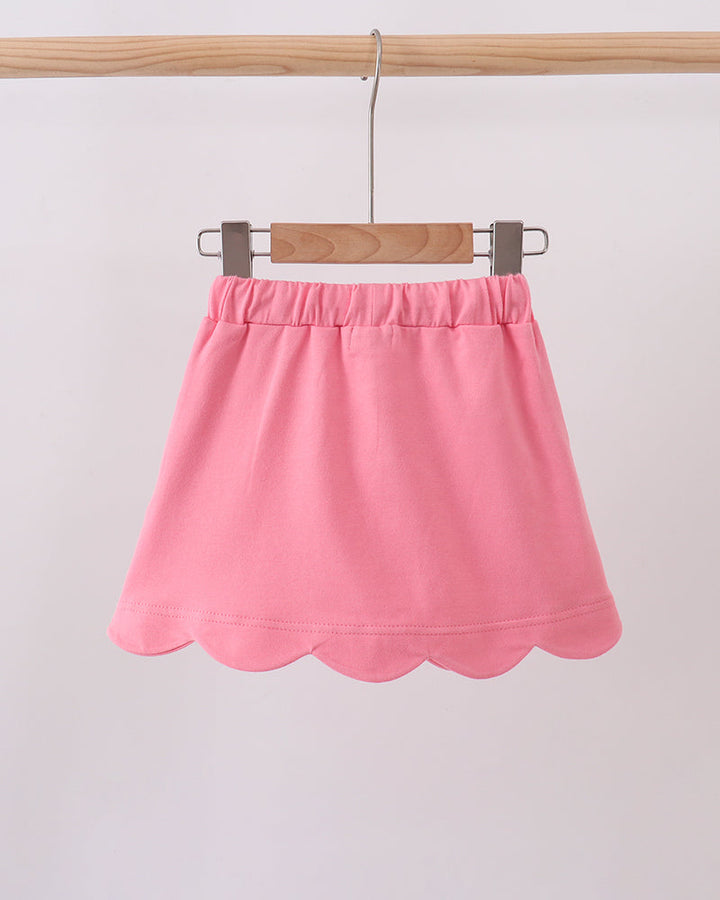 Deep pink kids skort on hanger with elastic waistband and scallop hem