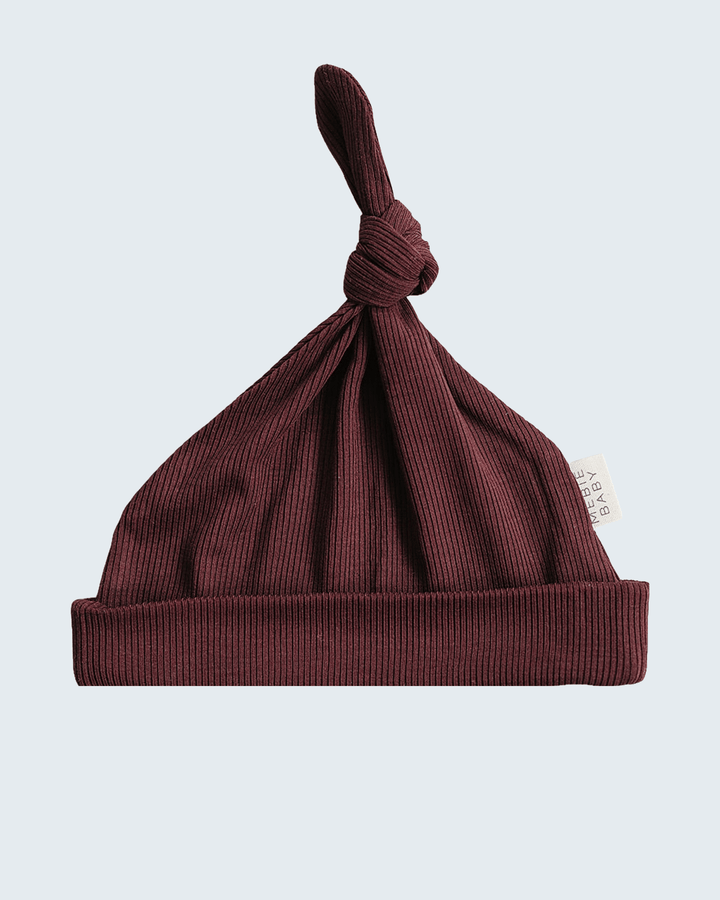 Newborn ribbed bamboo knot hat in dark violet, gathered top knot