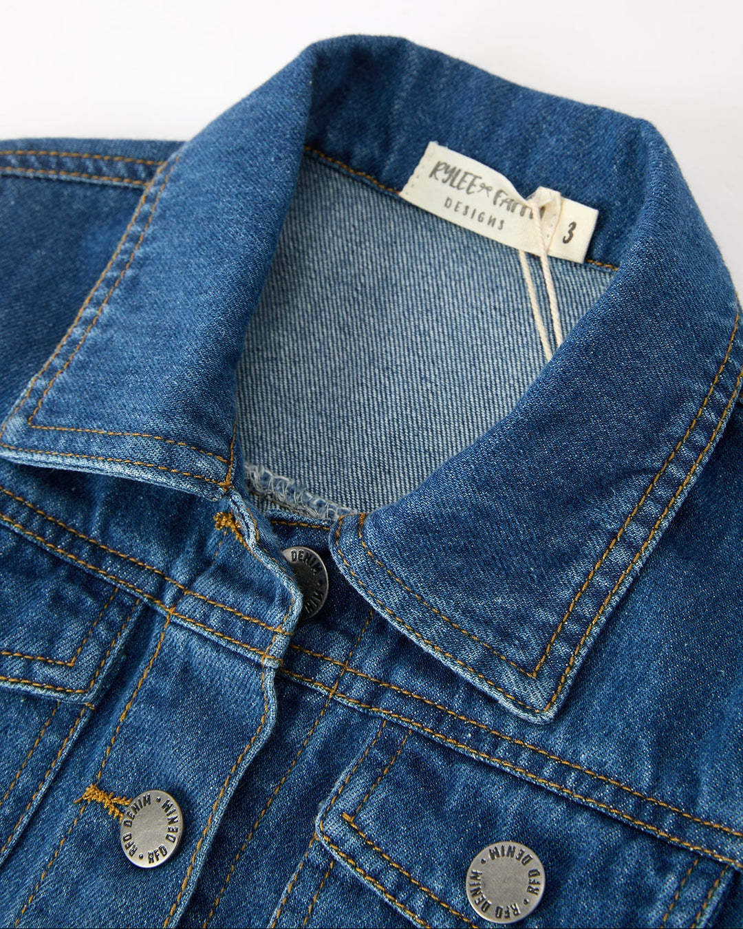 Girls denim jacket collar and button placket close-up