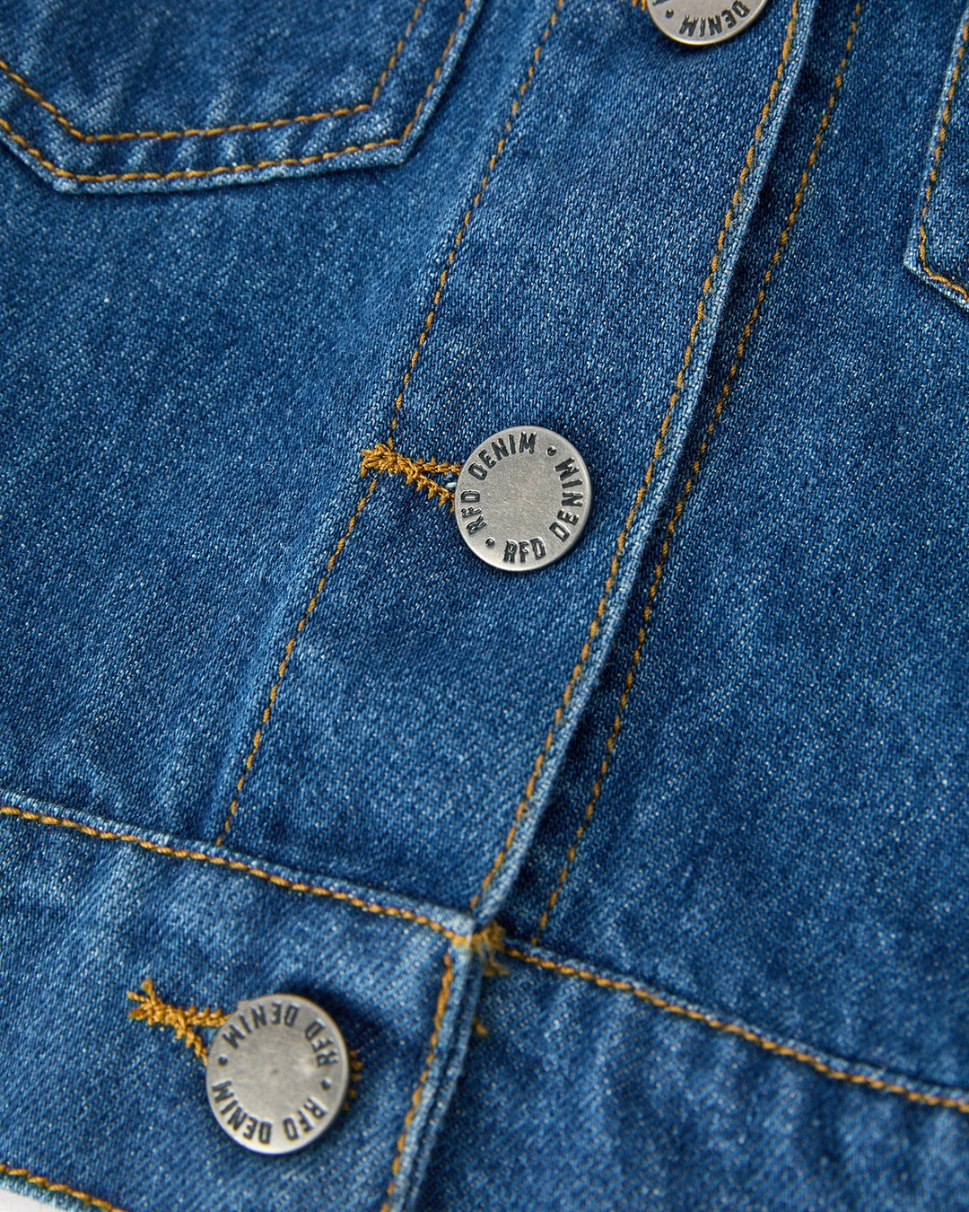 Girls blue denim jacket with round logo buttons and contrast stitching