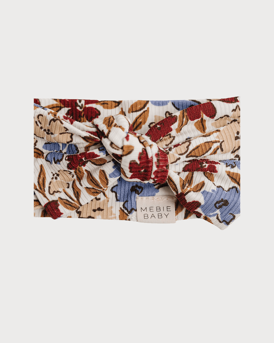 Floral ribbed bamboo head wrap in tan with red, rust, and navy; front knot, Mebie Baby tag