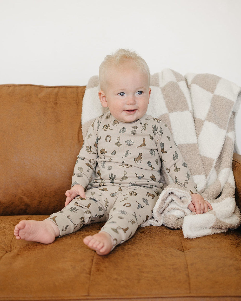 Baby wearing cream desert animal print cotton pajama set with long sleeves and pants