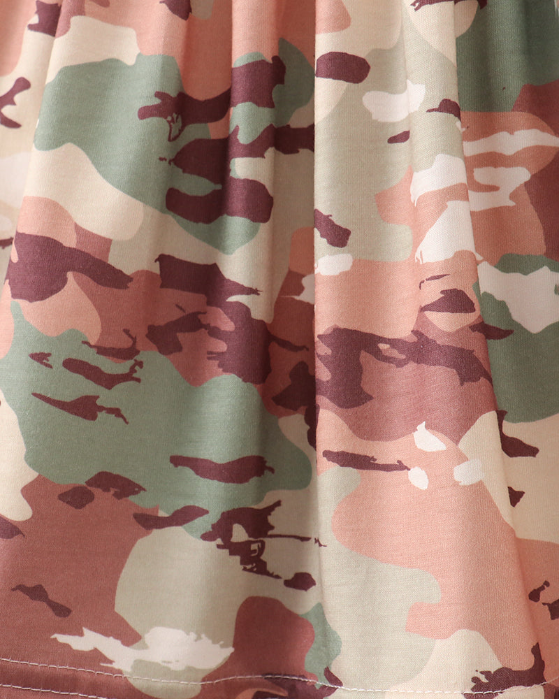 Close-up of camouflage fabric with pink, green, and brown colors.