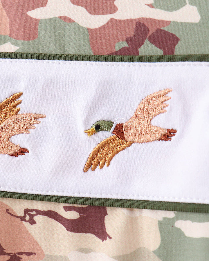 Embroidered duck design on a camouflage-patterned fabric