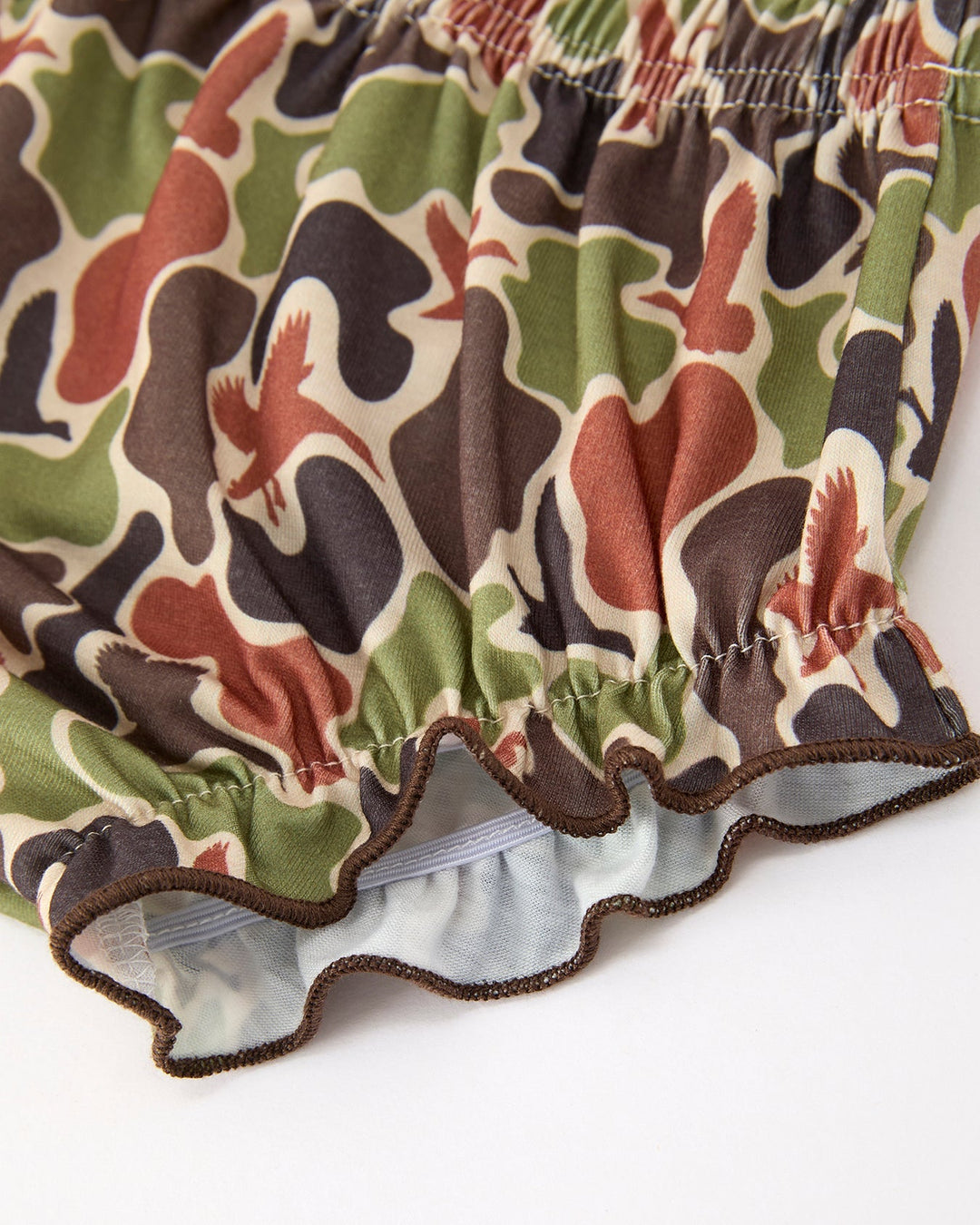 Camouflage-patterned bloomers on a white background