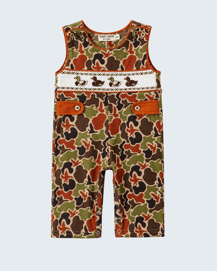 Camouflage-patterned overalls with brown accents on a light gray background